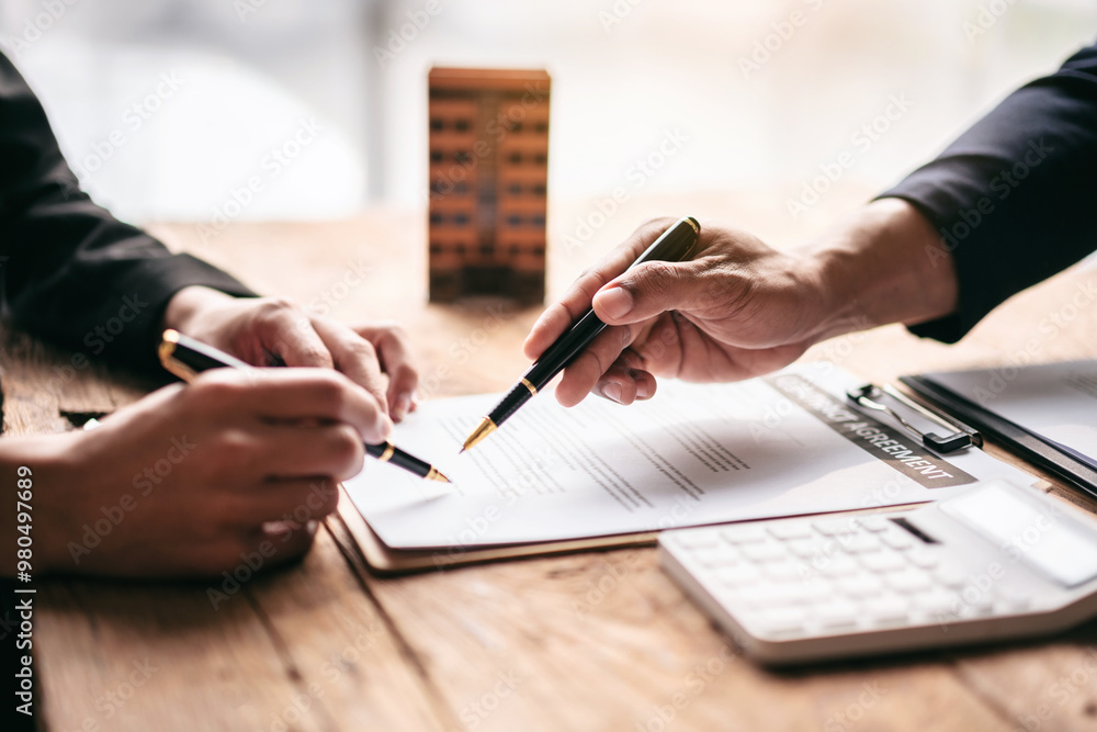 Poster two people are signing a document on a table
