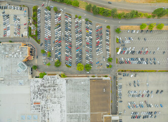 A parking lot with many cars and a building in the background © Anton