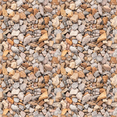 Brown and grey color crushed stone railway embankment surface texture top view seamless pattern 