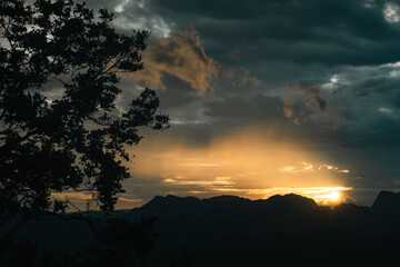 Majestic Mountain at Sunset with Sky and Cloudscape, Beautiful Landscape Captured in the Evening Light as the Sun Sets and Horizon Glows Orange, Transitioning from Dusk to Dawn with Sunlight