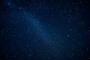 Obraz premium A dark night sky with stars and the Milky Way galaxy in view. 