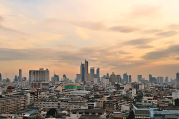 Obraz premium View onto the skyline of Bangkok before sunset, skyscrapers under a cloudy sky, Thailand