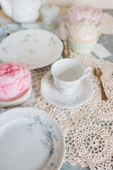a teacup and saucer are on a table with a plate, tea time