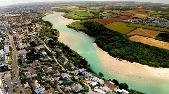 Aerial drone shot over the coastal town of Newquay in Cornwall, United Kingdom. High view of the Gannel river.