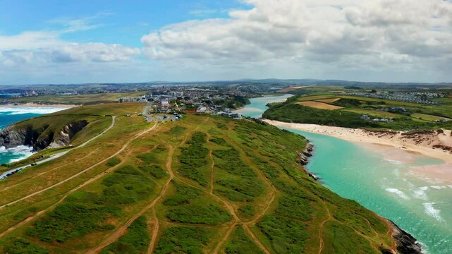Aerial drone shot over the coastal town of Newquay in Cornwall, United Kingdom. High view of the Gannel river.