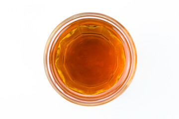 Sesame oil in clear glass isolated on white background top view flat lay stack.