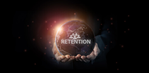 Customer retention or employee retention concept. Focus on marketing, business and employee management. The word 'RETENTION' with hands holding the Earth. Keeping team or customer engagement.