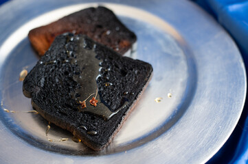 Burnt bread on the silver plate