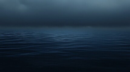 Obraz premium A serene view of calm blue water under a moody, overcast sky, creating a tranquil atmosphere for relaxation and reflection.