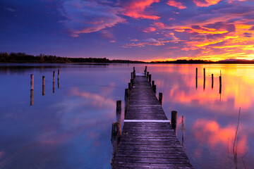 Fototapeta premium Wooden Pier by Lake Chiemsee at Sunrise, Bavaria, Germany