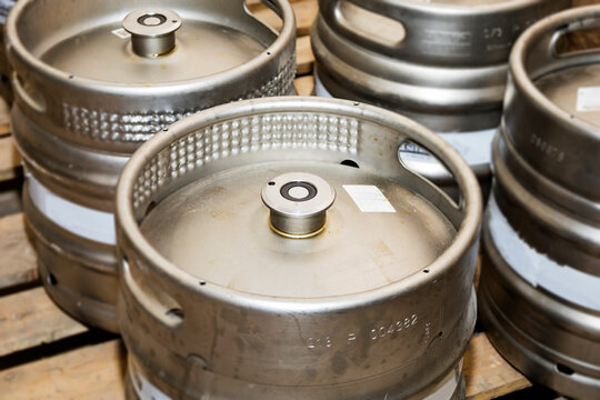 A meticulously stacked collection of beer kegs prepared and ready for distribution delivery