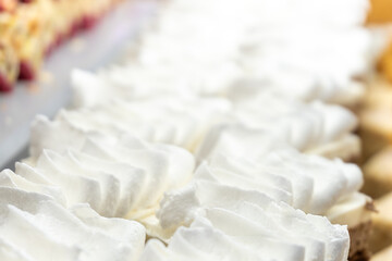 Cream-topped pastries. Close-up. Restaurant menu.