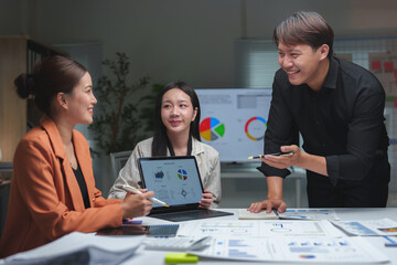 Business team giving advice Meeting and brainstorming, financial investment, real estate project, strategy, planning, calculation, pointing at graph chart on desk at office.