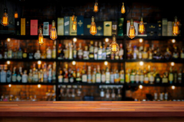Wooden table with blurry liquor bar background