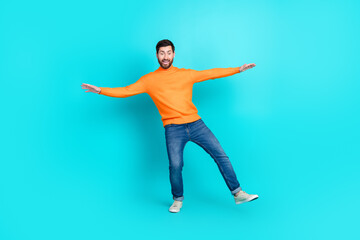 Photo of funny nice glad man wear stylish clothes fall down empty space isolated on cyan color background