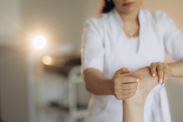 Beautiful woman receiving foot massage in spa salon