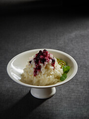 cold appetiser vegetable mash potato with lime sweet fruit blueberry jam sauce peppermint in plate on rock table asian healthy halal vegan food cuisine restaurant banquet menu for cafe