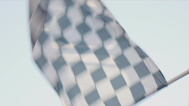 Racing marshal waving Checkered race at finish line on a raceway. Victory, achievement, success and sport concept. Grand Prix. Slow motion