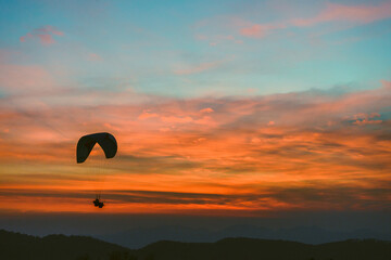 A paraglider sailing during the the sunset in the Himalayas.