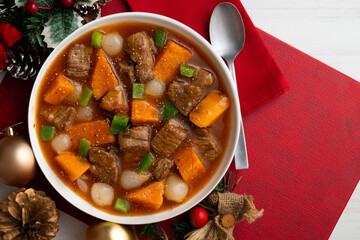 Beef stew with pumpkin and green beans. Top view table with Christmas decoration.