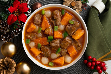 Beef stew with pumpkin and green beans. Top view table with Christmas decoration.