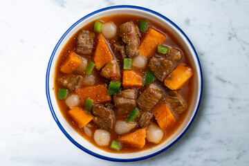 Beef stew with pumpkin and green beans. Top view table with  decoration.