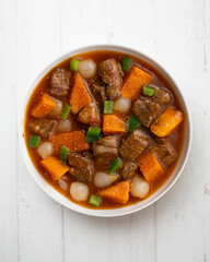Beef stew with pumpkin and green beans. Top view table with  decoration.