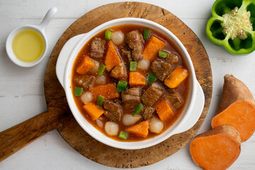 Beef stew with pumpkin and green beans. Top view table with  decoration.
