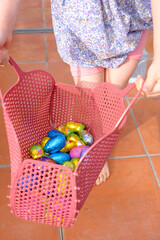 child with eggs in a basket