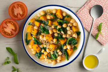 Chickpea stew with pumpkin and spinach. Top view table with Christmas decoration.