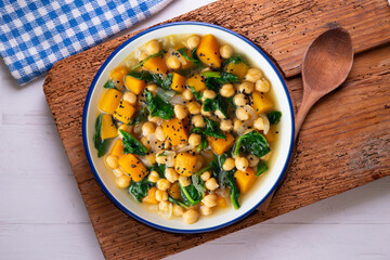 Chickpea stew with pumpkin and spinach. Top view table with Christmas decoration.