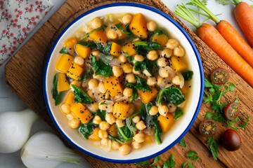 Chickpea stew with pumpkin and spinach. Top view table with Christmas decoration.