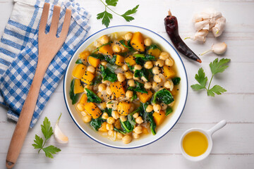 Chickpea stew with pumpkin and spinach. Top view table with Christmas decoration.