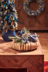 Christmas style Christmas centerpiece with rich blues and greens decor on a wooden table in the interior