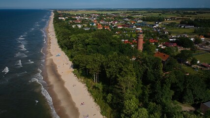 Aerial view of Gąski's lighthouse and scenic coastline on a bright summer day. © Grzegorz