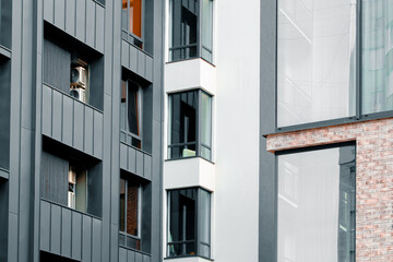 condominium city scape down town dense building narrow back street living district close local facade view of walls corners balconies and windows of high skyscrapers