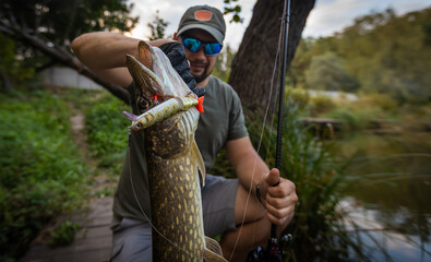 Fisherman and trophy Pike. Fishing background.