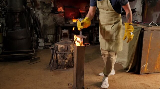 A strong blacksmith forged a large sword in an ancient forge, he holds a red-hot sword with sparks and smoke. 