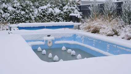 A small outdoor pool covered with snow. Pool under conservation