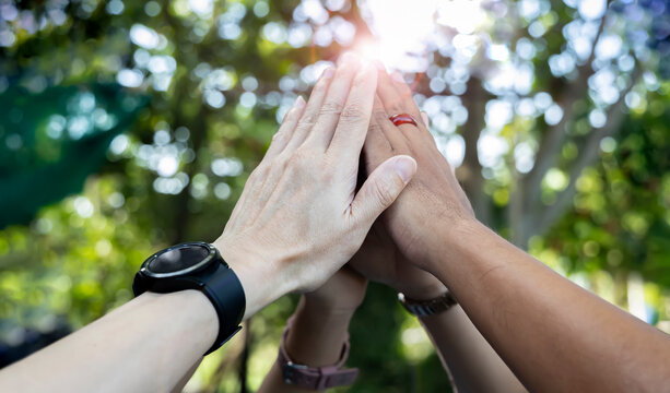 Teamwork Concept,Group of diversity people to greeting power tag team,Teamwork Join Hands Partnership Concept of people putting their hands together,Friends with hands showing unity..
