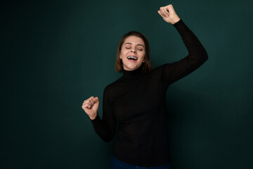 Woman in Black Shirt Holding Arms in the Air