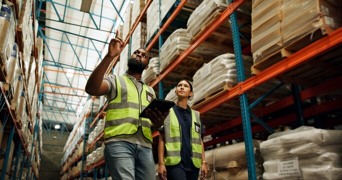 Woman, man and logistics in warehouse with tablet for quality control, stock management or delivery. People, factory and worker with technology, cargo and freight for supply chain or shipping company - Powered by Adobe