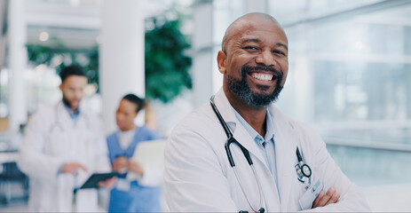 Doctor, black man and arms crossed with smile in portrait at hospital with pride for medical...