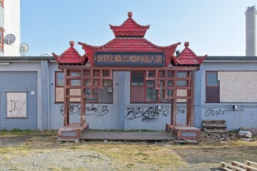 Old abandoned restaurant building with tower.