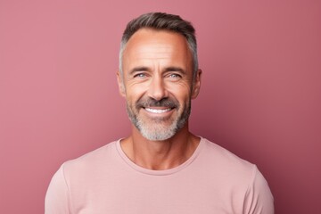 Obraz premium Portrait of a cheerful man in his 40s donning a trendy cropped top in front of pastel gray background