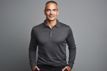 Fototapeta premium Portrait of a tender man in his 40s donning a classy polo shirt isolated in pastel gray background