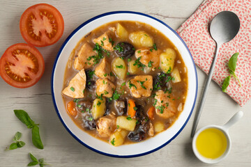 Turkey stew with prunes and potatoes. Top view table with  decoration.