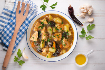 Turkey stew with prunes and potatoes. Top view table with  decoration.