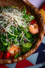 arugula salad with shrimp, cherry tomatoes, cheese