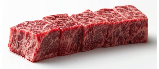 Wagyu a premium Japanese beef variety is renowned for its marbled red meat and ranks among the world s priciest meats It is pictured on a white background with room for text. with copyspace image